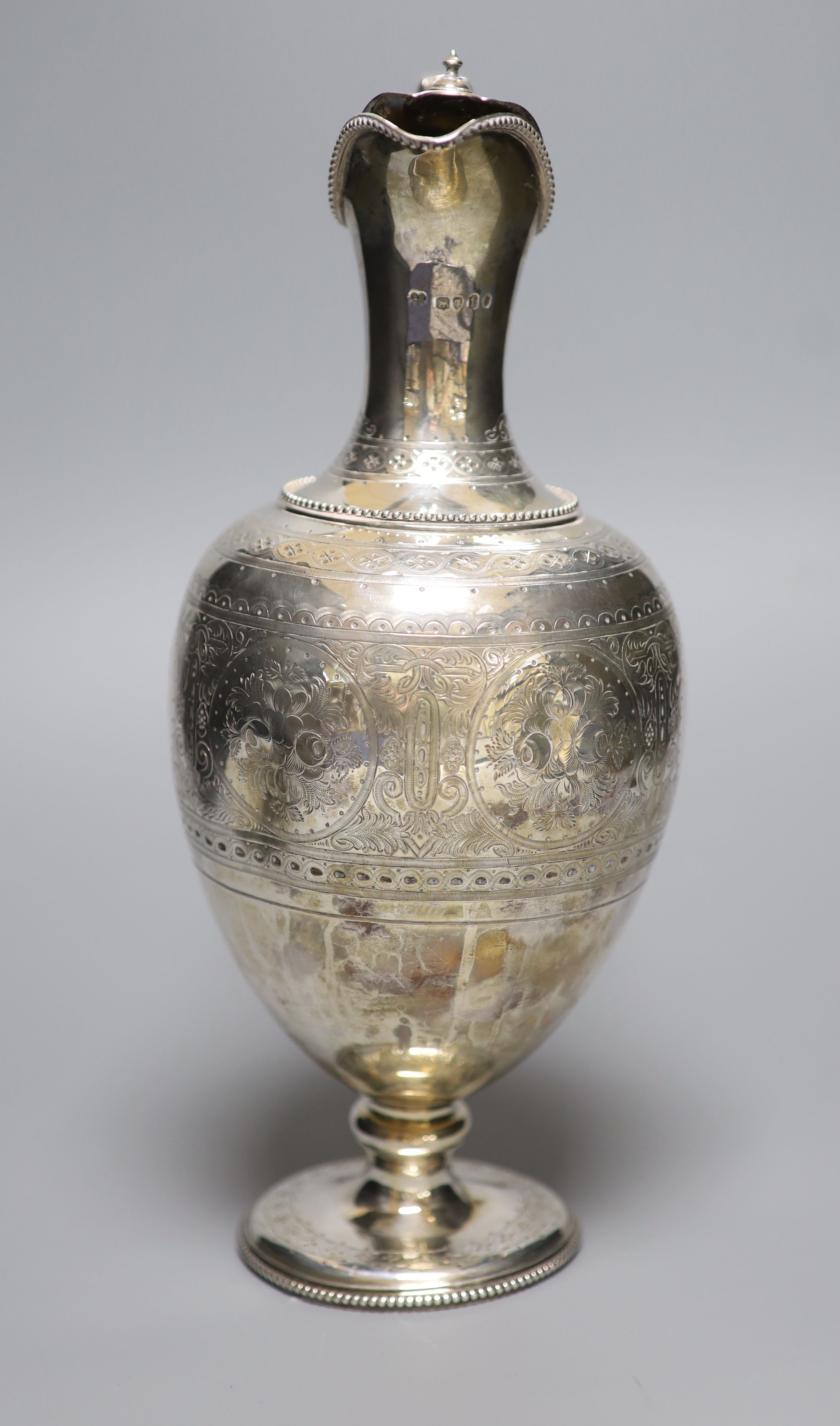 A Victorian engraved silver baluster hot water jug, Martin, Hall & Co, London, 1874